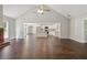 Open living room with vaulted ceiling, hardwood floors and a view of the kitchen at 1190 Lake Stone Lea Dr, Oxford, GA 30054