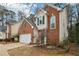 Two story brick home with landscaping and a green door at 485 Kensington Parc Dr, Avondale Estates, GA 30002