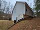 Gray siding home with a slight incline in the backyard at 4671 W Lake Se Dr, Conyers, GA 30094