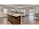 Open concept kitchen with granite island, stainless steel appliances, and hardwood floors at 1403 Flathead River Ln, Marietta, GA 30064