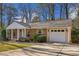 Brick ranch house with a spacious driveway and mature trees at 1626 Delia Dr, Decatur, GA 30033