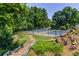 Two tennis courts with surrounding trees and brick pathway at 1626 Delia Dr, Decatur, GA 30033