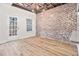 Dining area with exposed beams, brick wall, and access to the backyard at 331 Antebellum Pl, Woodstock, GA 30188