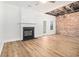 Living room featuring hardwood floors, fireplace, and exposed beams at 331 Antebellum Pl, Woodstock, GA 30188