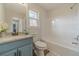 Clean bathroom with blue vanity, granite countertop and bathtub at 3581 Camelot Way, Loganville, GA 30052