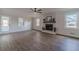 Spacious living room with fireplace, wood floors, and lots of natural light at 3581 Camelot Way, Loganville, GA 30052