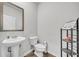 Clean bathroom with pedestal sink and shelving at 4929 Calgary Dr, Douglasville, GA 30135