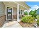Covered front porch with seating area and brick columns at 4929 Calgary Dr, Douglasville, GA 30135