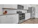 White shaker cabinets, stainless steel appliances, and granite countertops at 4929 Calgary Dr, Douglasville, GA 30135