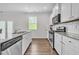 Open concept kitchen with island, stainless steel appliances, and white cabinets at 4929 Calgary Dr, Douglasville, GA 30135