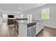 Open kitchen with island, granite countertops, and stainless steel appliances at 4929 Calgary Dr, Douglasville, GA 30135