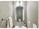 Small half bathroom with oval mirror and neutral-toned walls at 3045 Wyntree Dr, Peachtree Corners, GA 30071