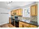 Modern kitchen with granite countertops and wood cabinets at 3045 Wyntree Dr, Peachtree Corners, GA 30071