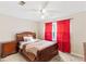 Bedroom with wood sleigh bed and red curtains at 3680 Edenbourgh Pl, Marietta, GA 30066