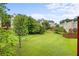 Community backyard with lush green grass and mature trees at 450 Abbotts Mill Dr # 54, Duluth, GA 30097