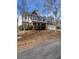 Two-story house with stone and shingle accents, a large driveway and manicured landscaping at 539 Greyhawk Way, Fairburn, GA 30213