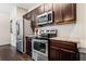 Modern kitchen with stainless steel appliances and granite countertops at 3192 Haynes Park Dr, Lithonia, GA 30038