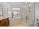 Bathroom with corner shower, bathtub, and wood vanity at 1204 Bridle Path, Marietta, GA 30068