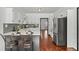 Modern kitchen with white cabinets, gray backsplash and breakfast bar at 1204 Bridle Path, Marietta, GA 30068