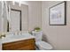 Modern powder room featuring a white vanity and wood floor at 1204 Bridle Path, Marietta, GA 30068