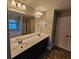 Double vanity bathroom with large mirror and tiled floor at 1241 St James Pl, Loganville, GA 30052