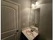 Small bathroom with vanity and mirror; neutral color palette at 1241 St James Pl, Loganville, GA 30052