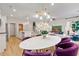 Bright dining area with white table and purple chairs, open to kitchen at 211 Sanctuary Dr, Mcdonough, GA 30253