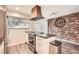 Modern kitchen with granite countertops, stainless steel appliances, and brick accent wall at 3119 Colonial Way # I, Atlanta, GA 30341