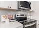 White kitchen with stainless steel appliances and quartz counters at 320 Shine Dr, Stockbridge, GA 30281