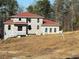 Two-story house under construction, red roof, and large windows at 515 Penny Ln, Loganville, GA 30052