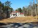 House under construction, red roof, and wooded setting at 515 Penny Ln, Loganville, GA 30052