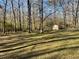 Wooded backyard with a storage shed at 4365 Miners Creek Rd, Lithonia, GA 30038