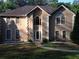 Tan two story house with arched windows and a walkway at 4365 Miners Creek Rd, Lithonia, GA 30038