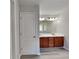 Double vanity bathroom with wood cabinets and updated fixtures at 4141 Alexis Ct, Loganville, GA 30052