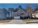 Two-story house with a white garage door and landscaping at 4141 Alexis Ct, Loganville, GA 30052