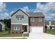 Two-story house with brick and siding, a two-car garage, and a landscaped lawn at 76 Silverton Dr, Dacula, GA 30019