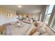 Bright and airy living room with beige sofas, a coffee table, and large windows at 76 Silverton Dr, Dacula, GA 30019