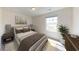 Bright bedroom with a large bed, window, and modern decor at 86 Silverton Dr, Dacula, GA 30019