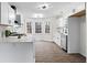 Modern white kitchen with stainless steel appliances and hardwood floors at 2909 Emerald Ln, Acworth, GA 30102