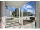 Covered porch with white railing, offering a view of the neighborhood at 4628 Rolling Brook Ct, Union City, GA 30291