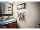 Stylish powder room with dark vanity, granite countertop, and mirror at 5473 Olde Plantation Dr, Douglasville, GA 30135