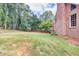 Large backyard with brick house and wooden fence at 736 Oxford Ct, Lilburn, GA 30047