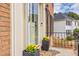 Front entrance with yellow flowers and storm door at 736 Oxford Ct, Lilburn, GA 30047