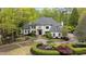 Luxury home with circular driveway and manicured landscaping at 6092 Carlisle Ln, Alpharetta, GA 30022