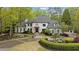 Stunning two-story home nestled on a wooded lot with circular driveway at 6092 Carlisle Ln, Alpharetta, GA 30022