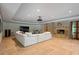 Finished basement boasts a large sectional sofa, fireplace, and hardwood floors at 6092 Carlisle Ln, Alpharetta, GA 30022