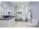 Modern bathroom with a soaking tub, walk in shower, and heated towel rack at 6092 Carlisle Ln, Alpharetta, GA 30022