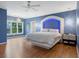 Blue bedroom with hardwood floors, large window and unique bed at 6092 Carlisle Ln, Alpharetta, GA 30022