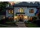 Elegant home exterior at dusk, featuring a grand entrance at 6092 Carlisle Ln, Alpharetta, GA 30022