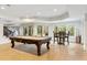 Basement game room with pool table, wet bar, and plenty of natural light at 6092 Carlisle Ln, Alpharetta, GA 30022